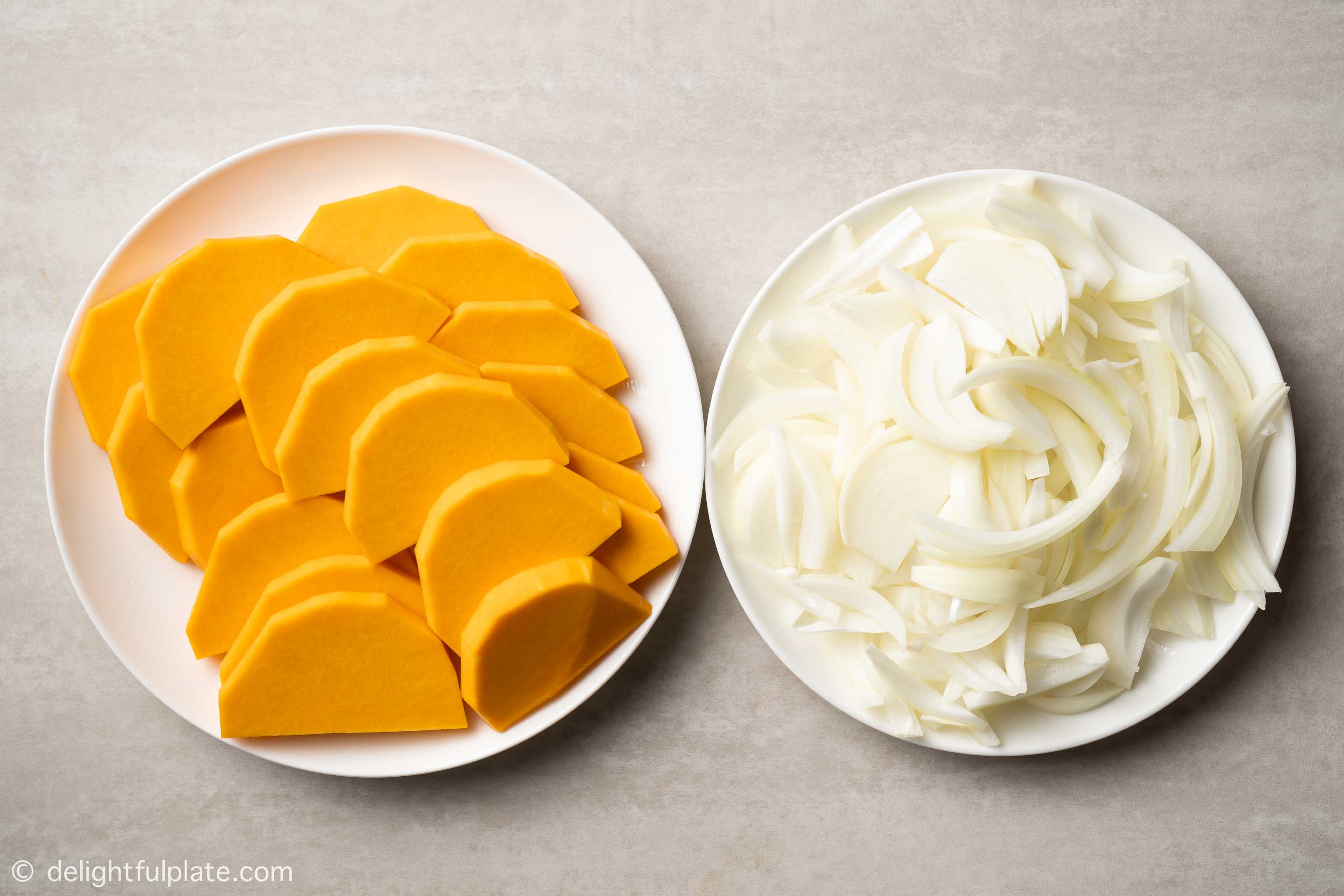 plates with sliced butternut squash and onions