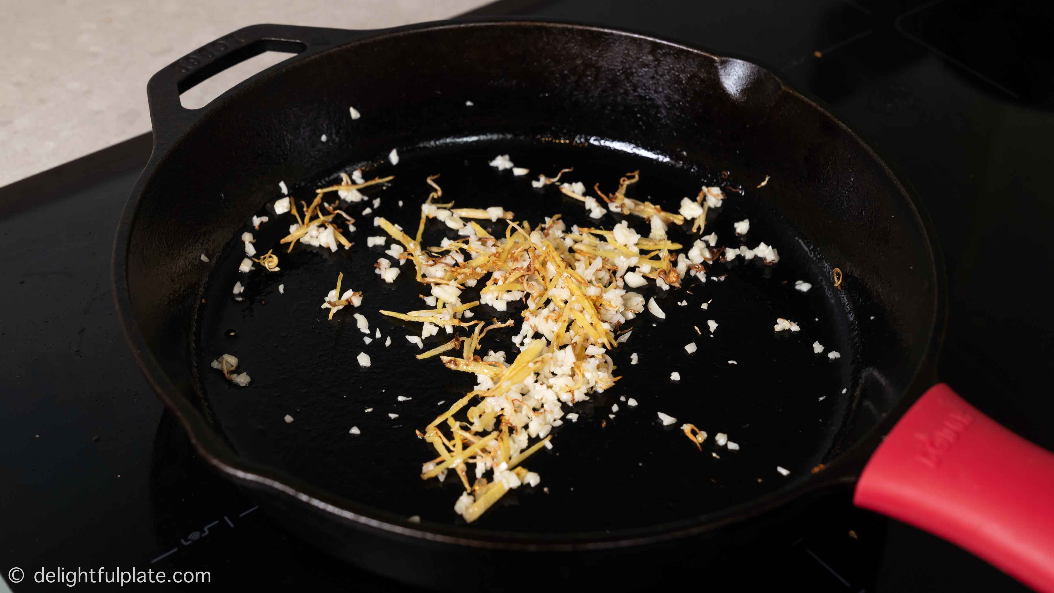sautéing ginger and garlic in the skillet