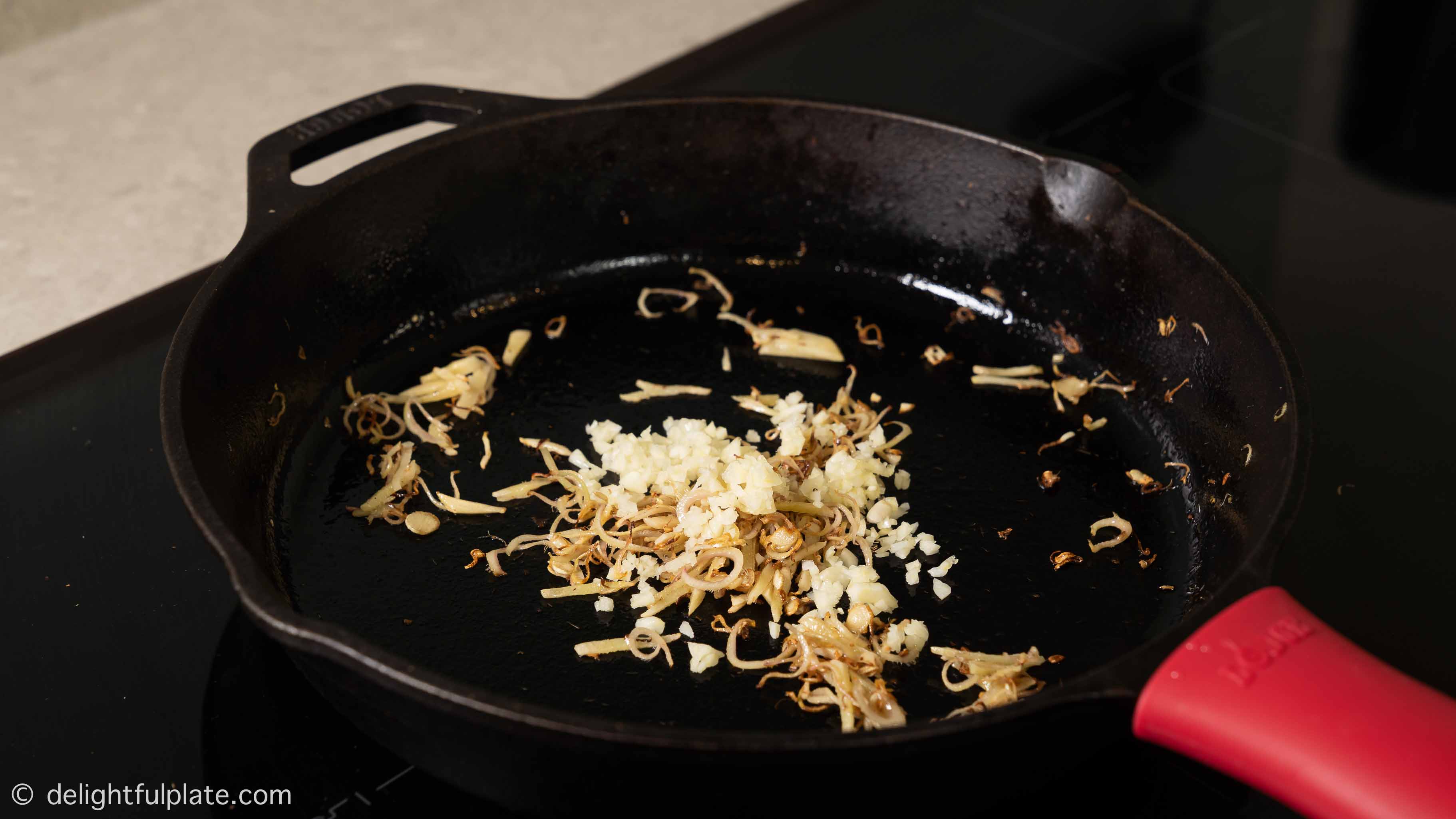 sautéing ginger and garlic in the skillet
