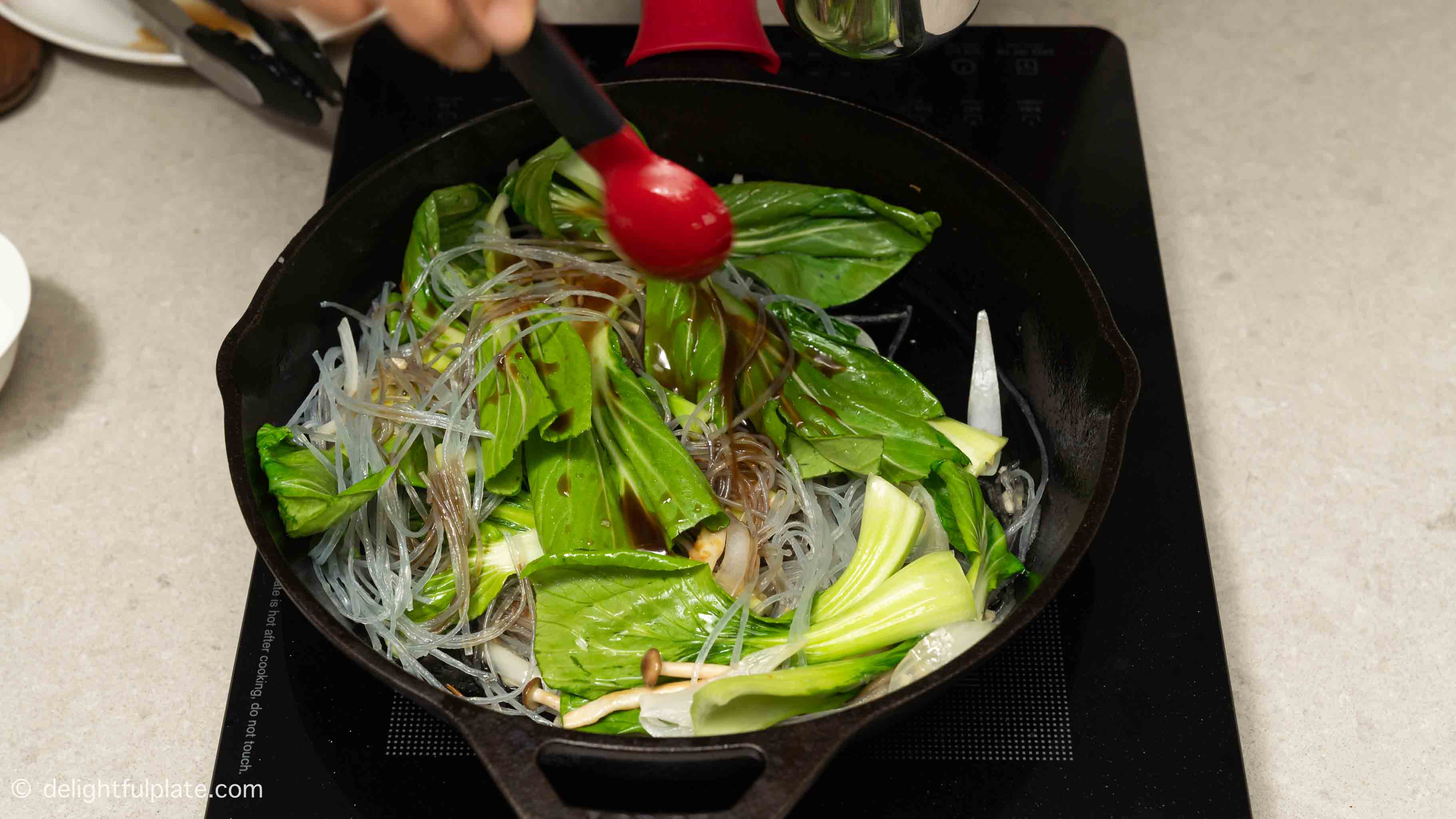 pour stir-fry sauce over the noodles and vegetables.