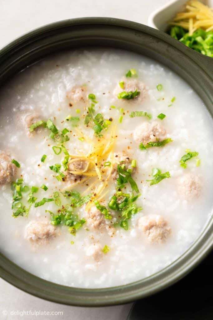 a small pot of congee with pork meatballs.