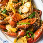 a plate of stir-fried crabs with scallion and ginger.