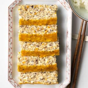 a plate with slices of Vietnamese vegetarian egg loaf.